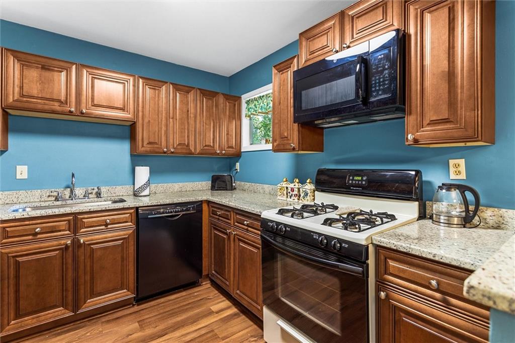 1610 Raleigh Circle Marietta, GA 30067 - Photo 13 of 33 a kitchen with stainless steel appliances granite countertop a stove a sink and a microwave