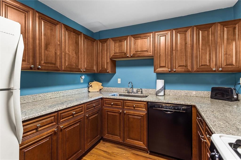 1610 Raleigh Circle Marietta, GA 30067 - Photo 15 of 33 a kitchen with stainless steel appliances granite countertop a sink stove and cabinets