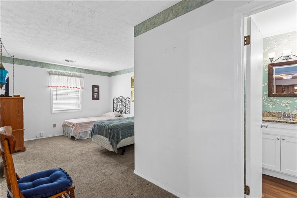 1610 Raleigh Circle Marietta, GA 30067 - Photo 22 of 33 a spacious bedroom with a bed and a window