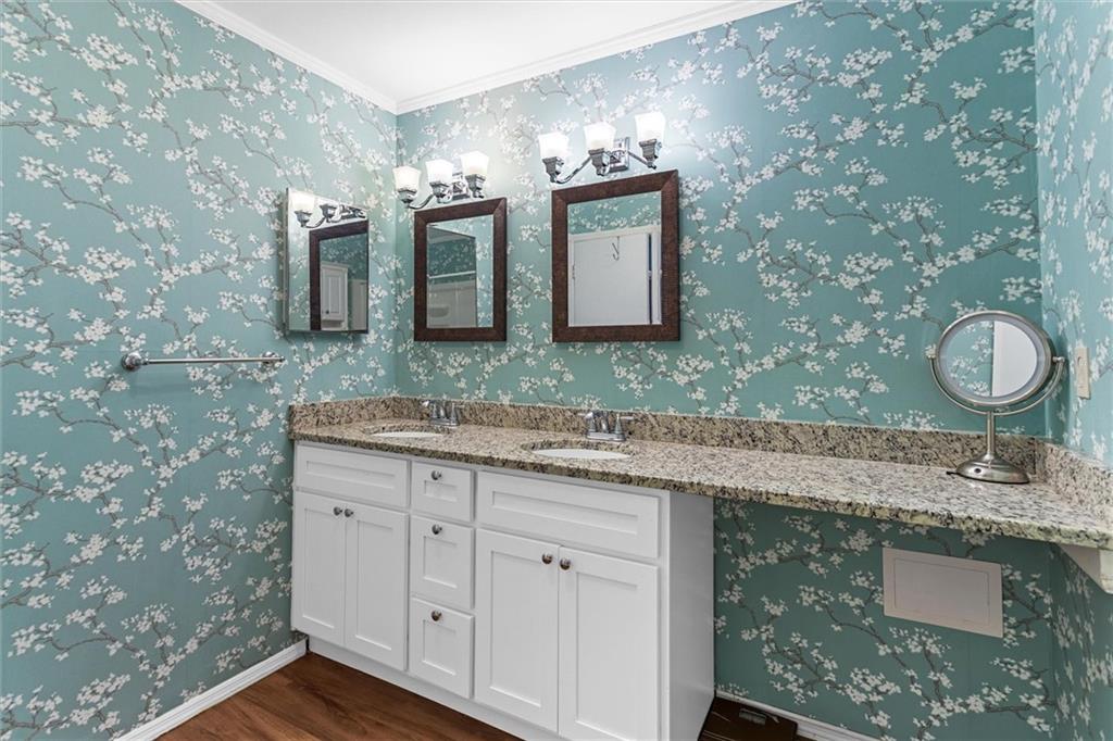 1610 Raleigh Circle Marietta, GA 30067 - Photo 25 of 33 a bathroom with a granite countertop sink a mirror and vanity
