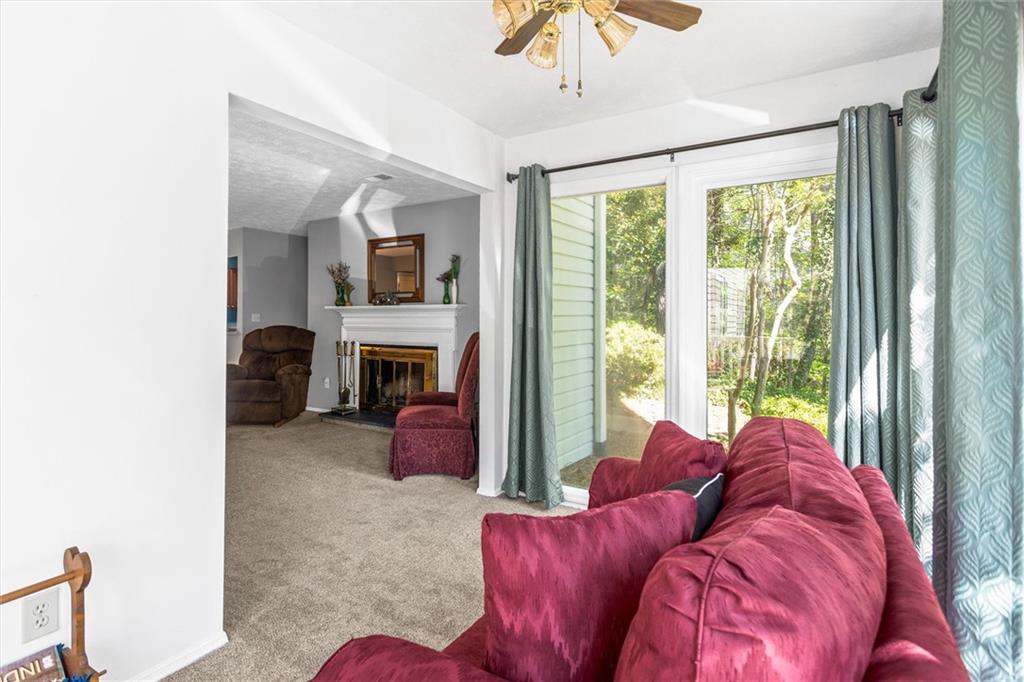 1610 Raleigh Circle Marietta, GA 30067 - Photo 7 of 33 a living room with furniture a fireplace and a large window