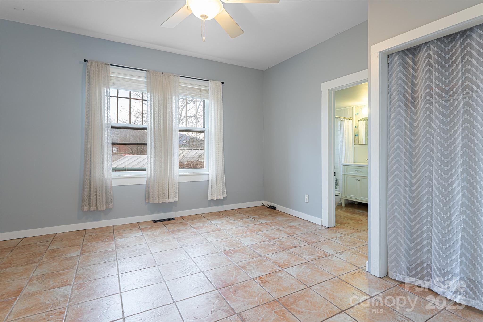 40 Jonestown Road Asheville, NC 28804 - Photo 11 of 46 a view of an empty room with window and chandelier fan