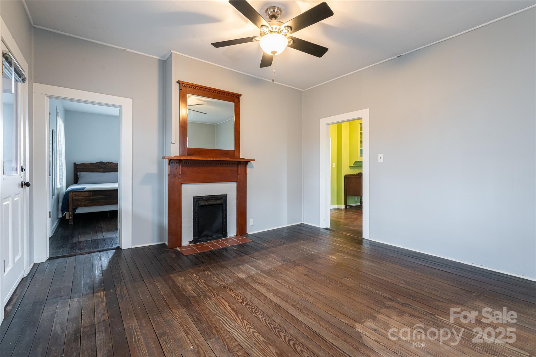 40 Jonestown Road Asheville, NC 28804 - Photo 6 of 46 a view of a livingroom with wooden floor a ceiling fan and a fireplace