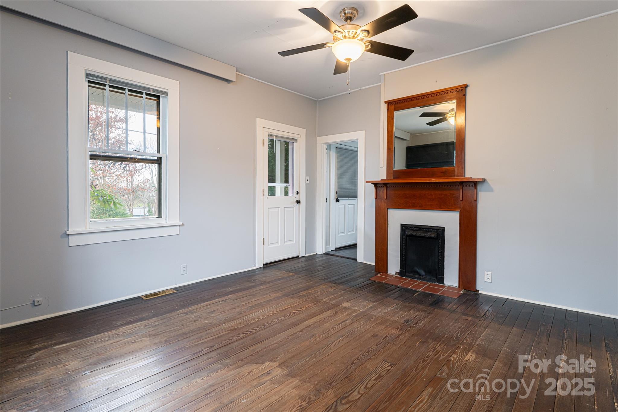 40 Jonestown Road Asheville, NC 28804 - Photo 7 of 46 a view of empty room with wooden floor and fan