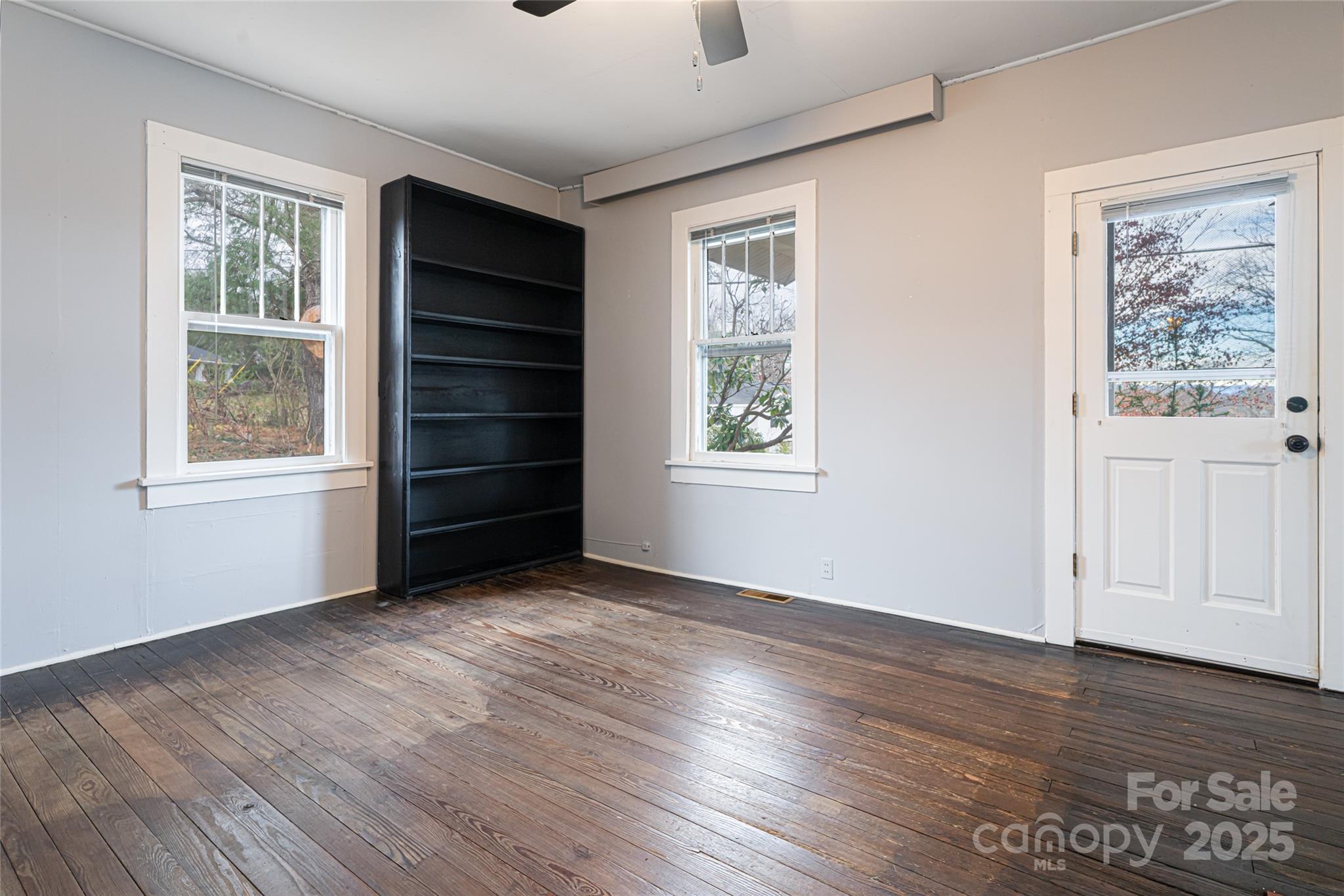 40 Jonestown Road Asheville, NC 28804 - Photo 8 of 46 a view of an empty room with a window and wooden floor