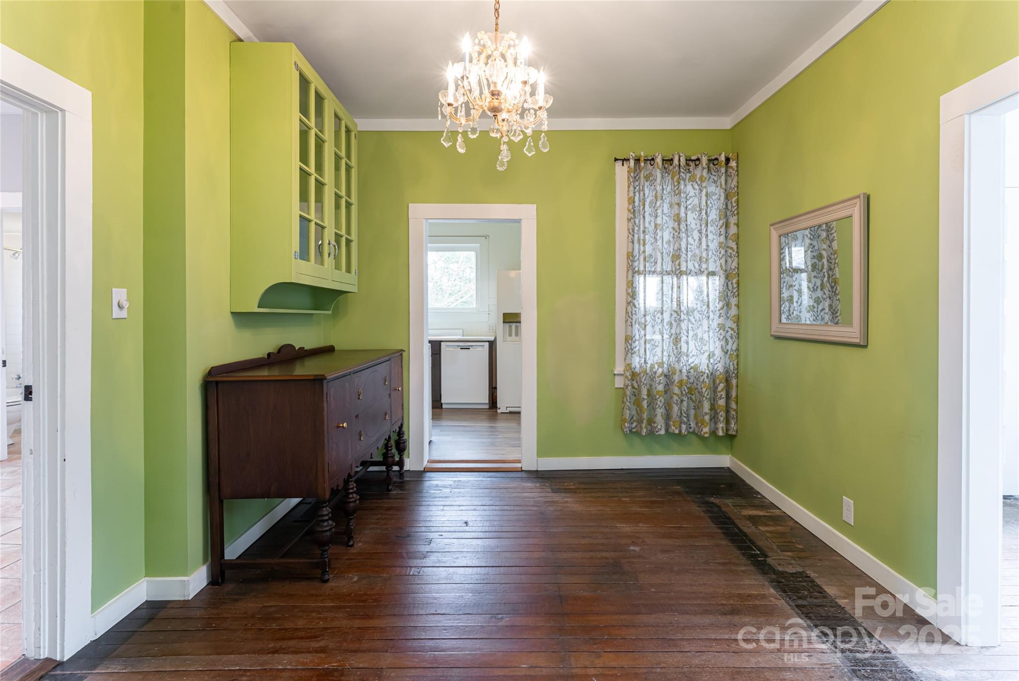 40 Jonestown Road Asheville, NC 28804 - Photo 9 of 46 a view of a hallway with wooden floor and a chandelier