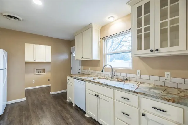a kitchen with a sink cabinets and window
