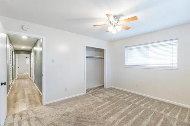 a view of a livingroom with a chandelier fan