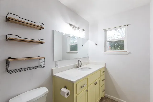 a bathroom with a sink toilet and vanity