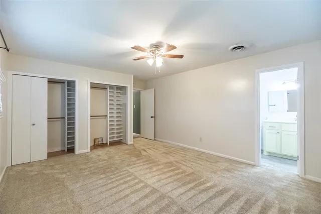 a view of a room with a ceiling fan and closet