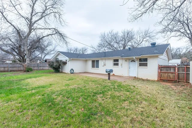a front view of house with yard and trees