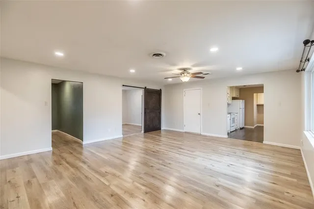 a view of an empty room with wooden floor