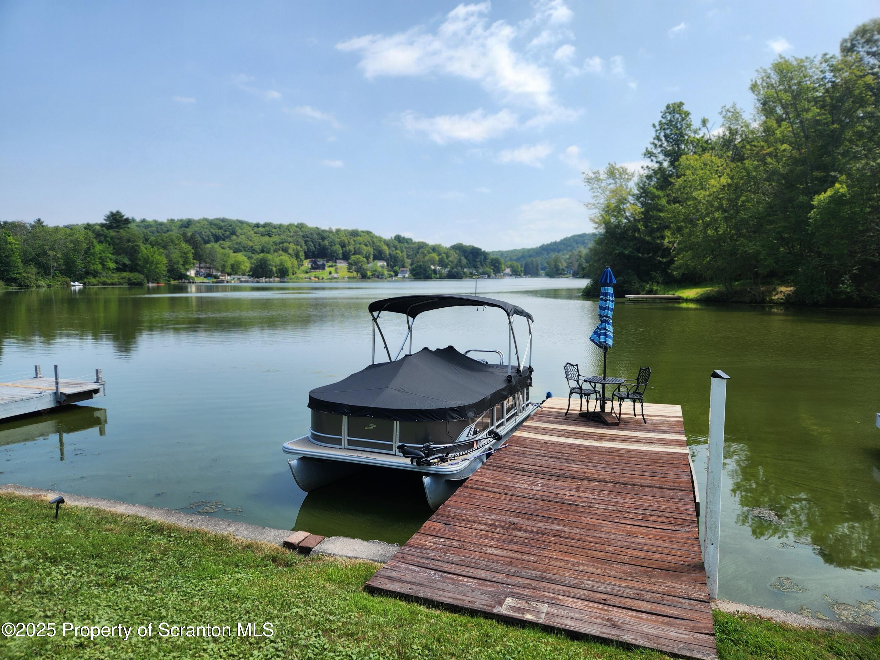 135 Pedrick Road Nicholson, PA 18446 - Photo 11 of 16 a front view of a house with a yard and a pond