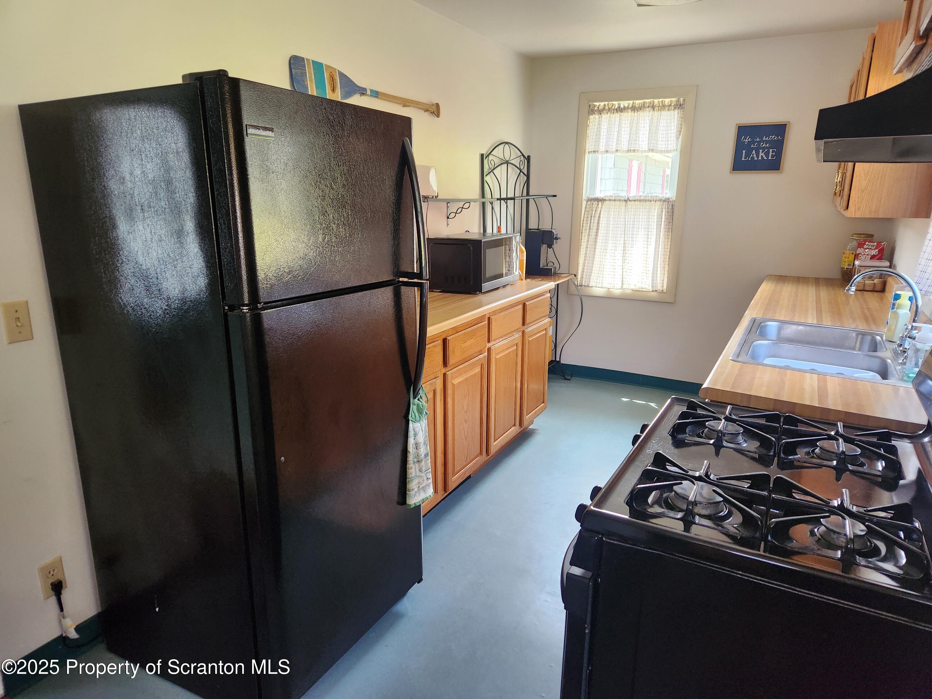 135 Pedrick Road Nicholson, PA 18446 - Photo 3 of 16 a kitchen with stainless steel appliances granite countertop a refrigerator and a stove