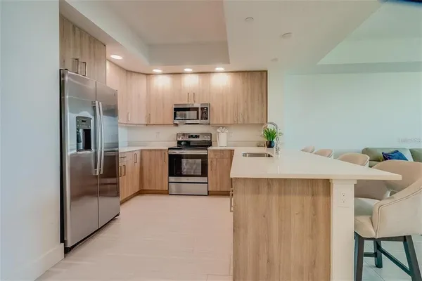 a kitchen with cabinets and a refrigerator