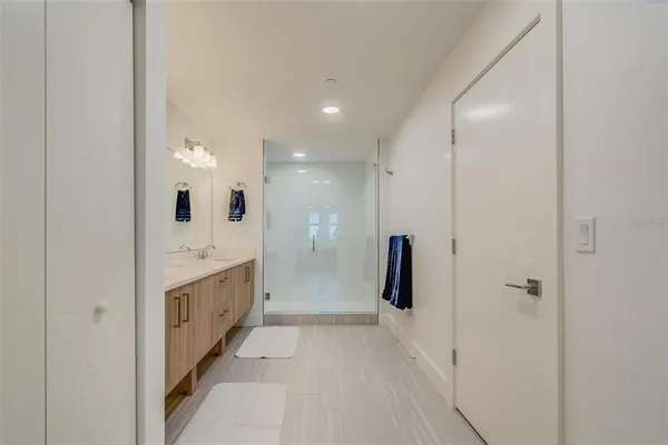 a large bathroom with a sink and a mirror