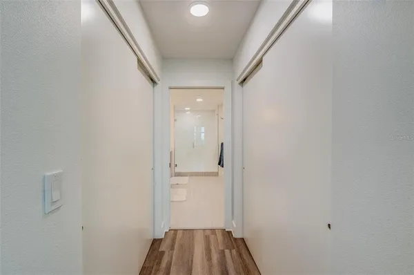 a bathroom with a granite countertop sink a toilet a mirror and shower