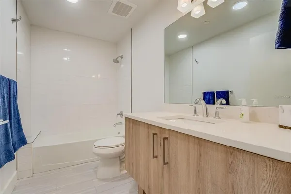 a bathroom with a sink vanity and a mirror