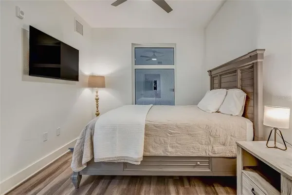 a bedroom with a bed and a flat screen tv