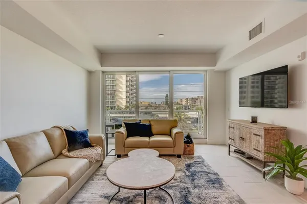 a living room with furniture fireplace and a flat screen tv