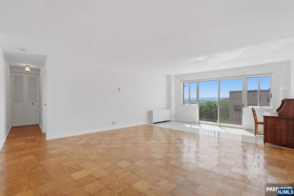 265 Main Street, Unit 704 Ridgefield Park, NJ 07660 - Photo 8 of 23 a view of an empty room with wooden floor and a window