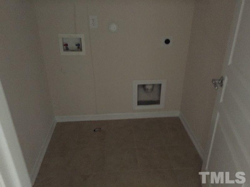 8215 Pilots View Drive Raleigh, NC 27617 - Photo 15 of 18 an empty room with a door