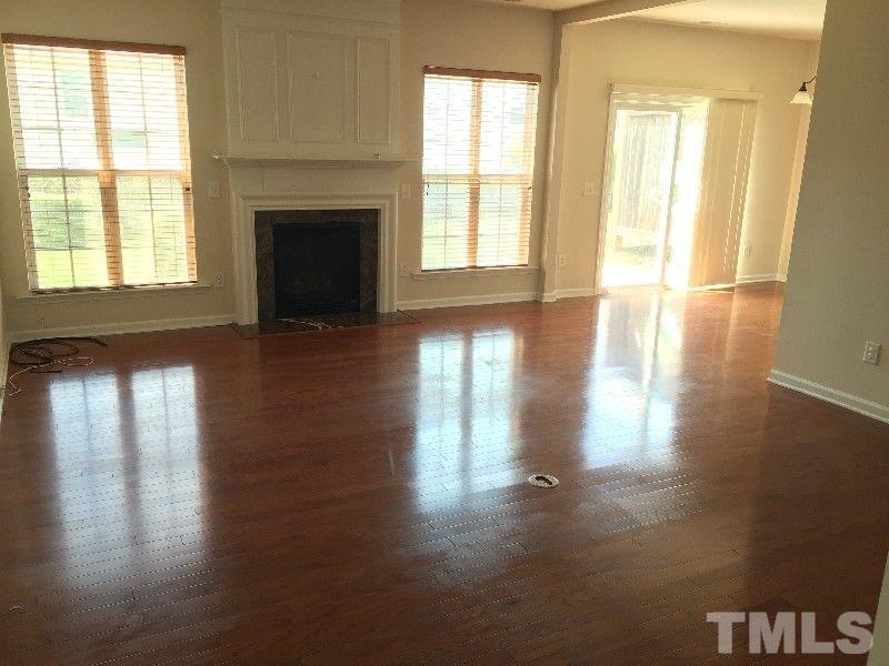 8215 Pilots View Drive Raleigh, NC 27617 - Photo 4 of 18 a view of empty room with wooden floor and fan