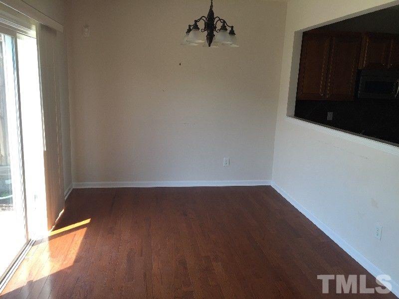 8215 Pilots View Drive Raleigh, NC 27617 - Photo 7 of 18 a view of an empty room with wooden floor and a window