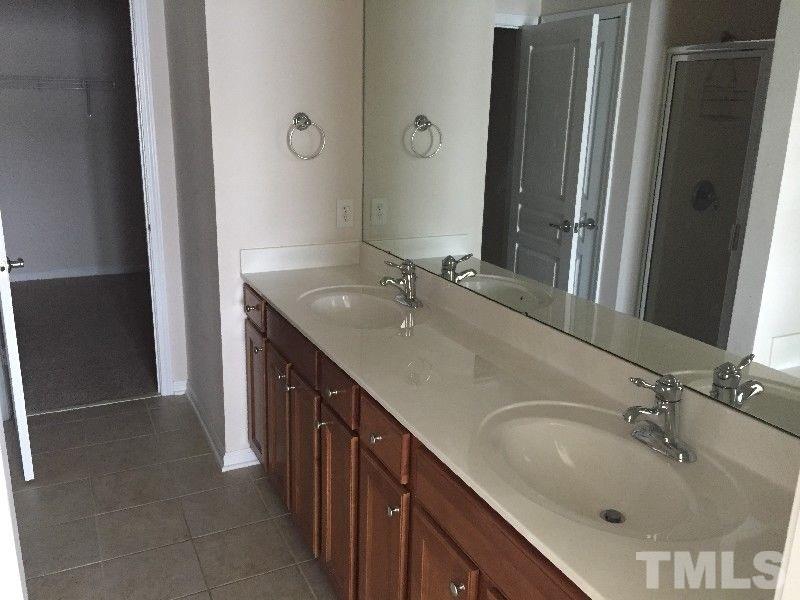 8215 Pilots View Drive Raleigh, NC 27617 - Photo 9 of 18 a bathroom with a double vanity sink a and mirror