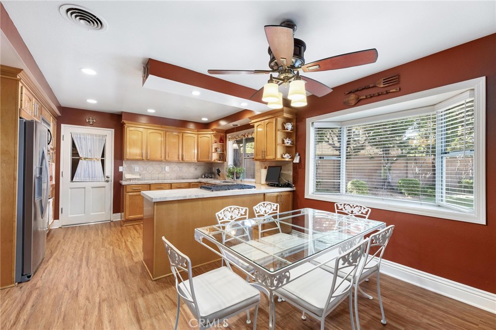 12110 Braemore Place Porter Ranch, CA 91326 - Photo 13 of 45 a view of a dining room with furniture window and wooden floor