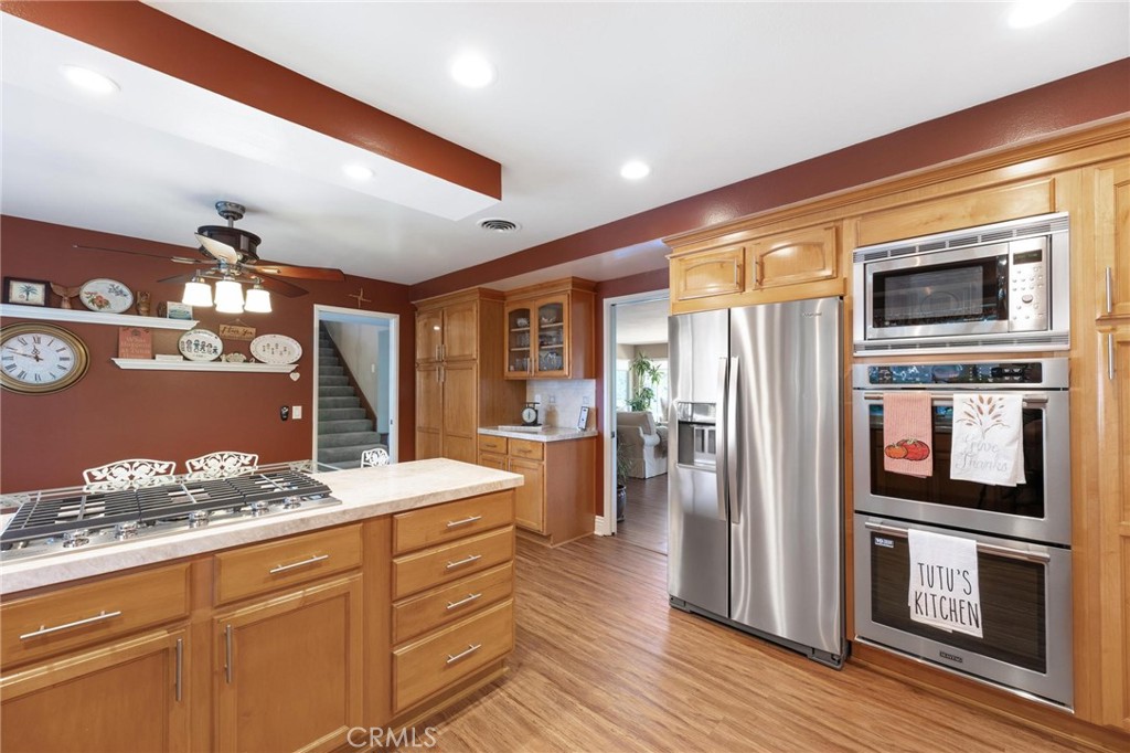 12110 Braemore Place Porter Ranch, CA 91326 - Photo 16 of 45 a kitchen with stainless steel appliances kitchen island granite countertop a stove refrigerator and cabinets