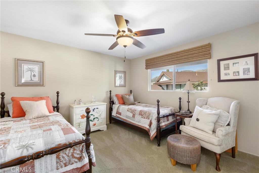 12110 Braemore Place Porter Ranch, CA 91326 - Photo 29 of 45 a bedroom with 2 bed and a chandelier