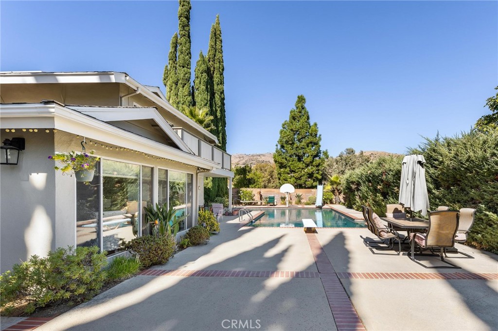 12110 Braemore Place Porter Ranch, CA 91326 - Photo 33 of 45 a view of a patio with couches table and chairs and potted plants