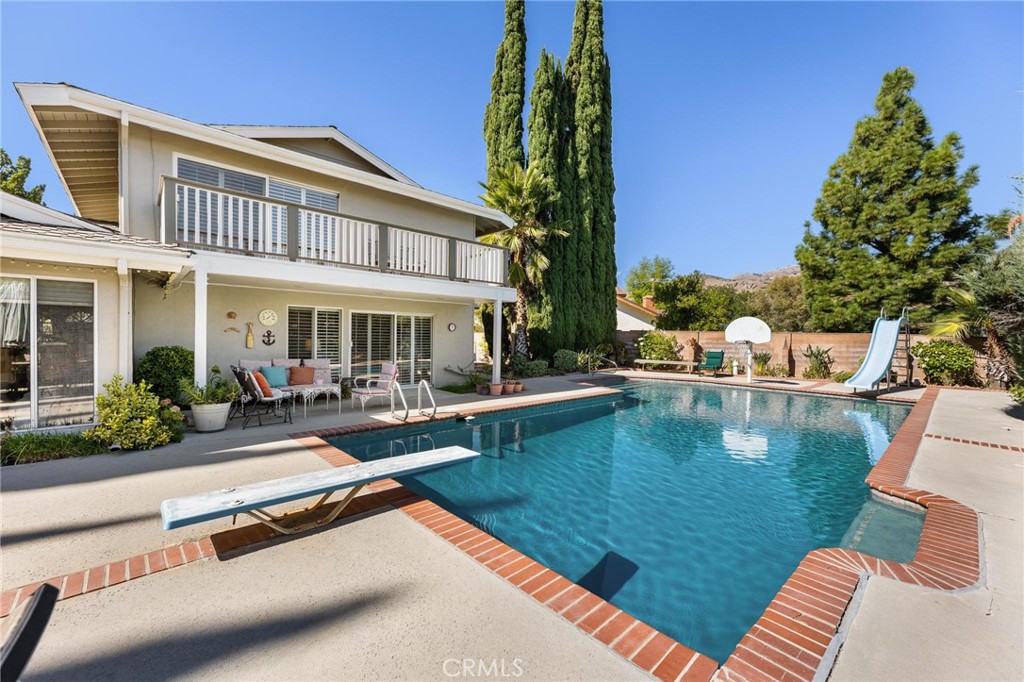 12110 Braemore Place Porter Ranch, CA 91326 - Photo 34 of 45 a view of a house with swimming pool and sitting area