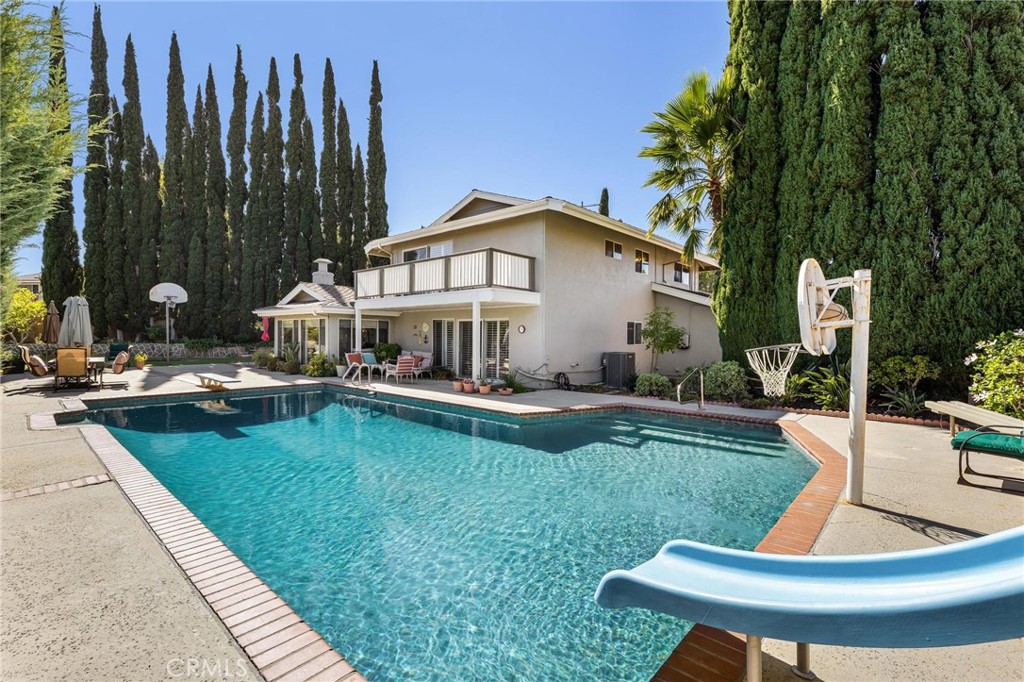12110 Braemore Place Porter Ranch, CA 91326 - Photo 35 of 45 a view of a house with swimming pool and sitting area