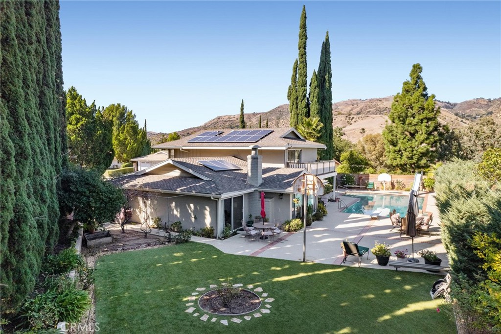 12110 Braemore Place Porter Ranch, CA 91326 - Photo 37 of 45 a view of a house with a yard porch and sitting area
