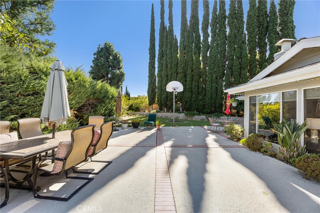 12110 Braemore Place Porter Ranch, CA 91326 - Photo 39 of 45 a view of a house with backyard sitting area and garden
