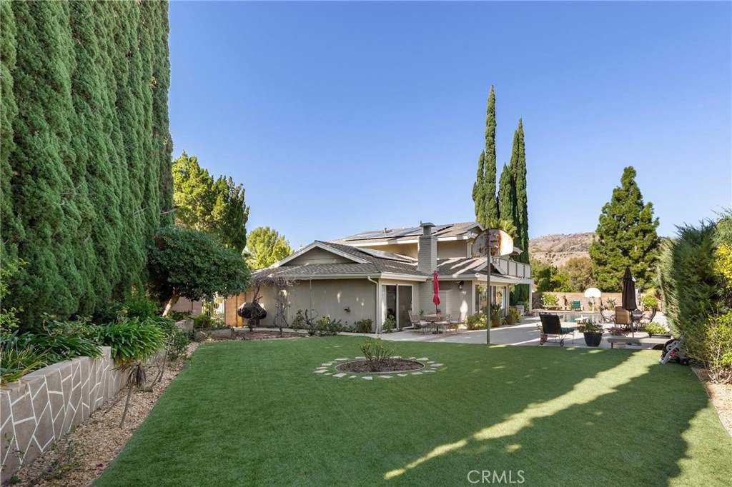 12110 Braemore Place Porter Ranch, CA 91326 - Photo 41 of 45 a front view of a house with a garden and plants