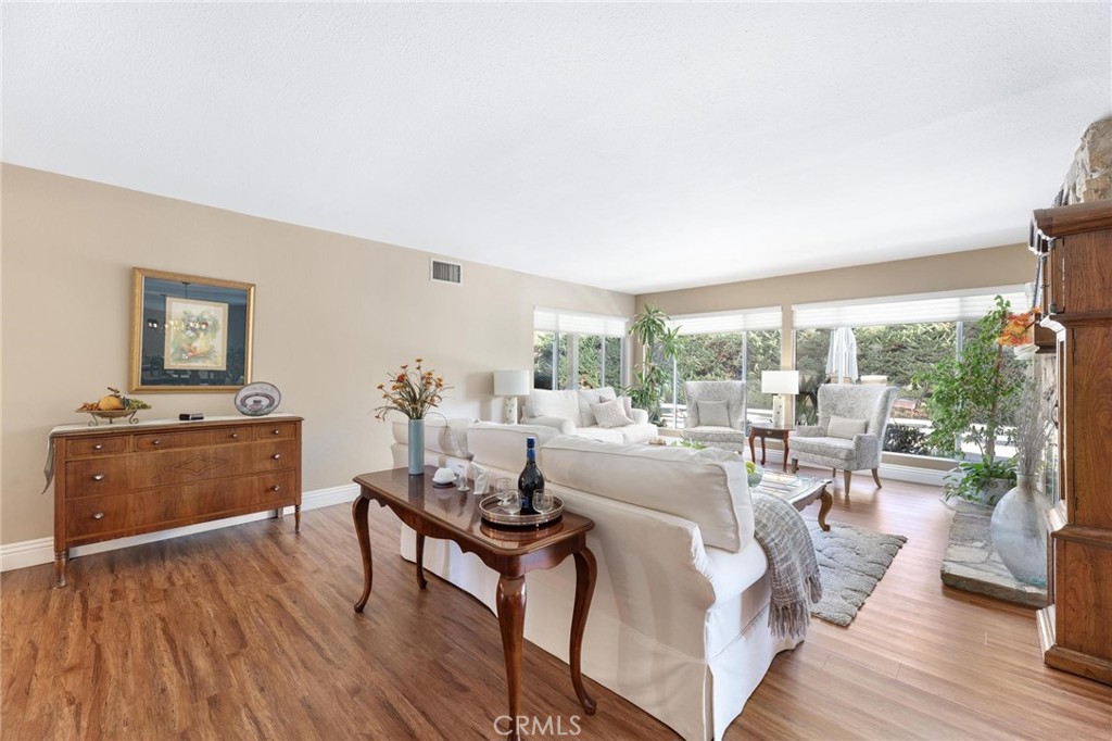 12110 Braemore Place Porter Ranch, CA 91326 - Photo 9 of 45 a living room with furniture and a wooden floor