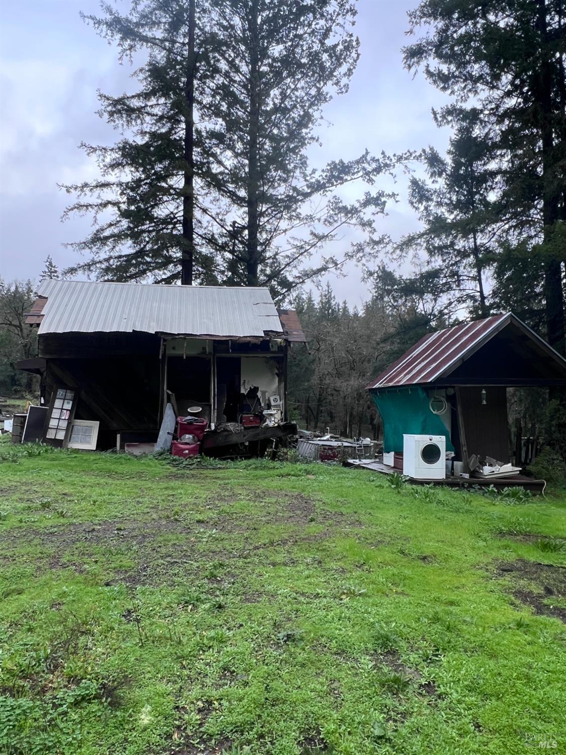 15785 Pole Mountain Road Cazadero, CA 95421 - Photo 12 of 44 a view of a house with a garden and sitting area