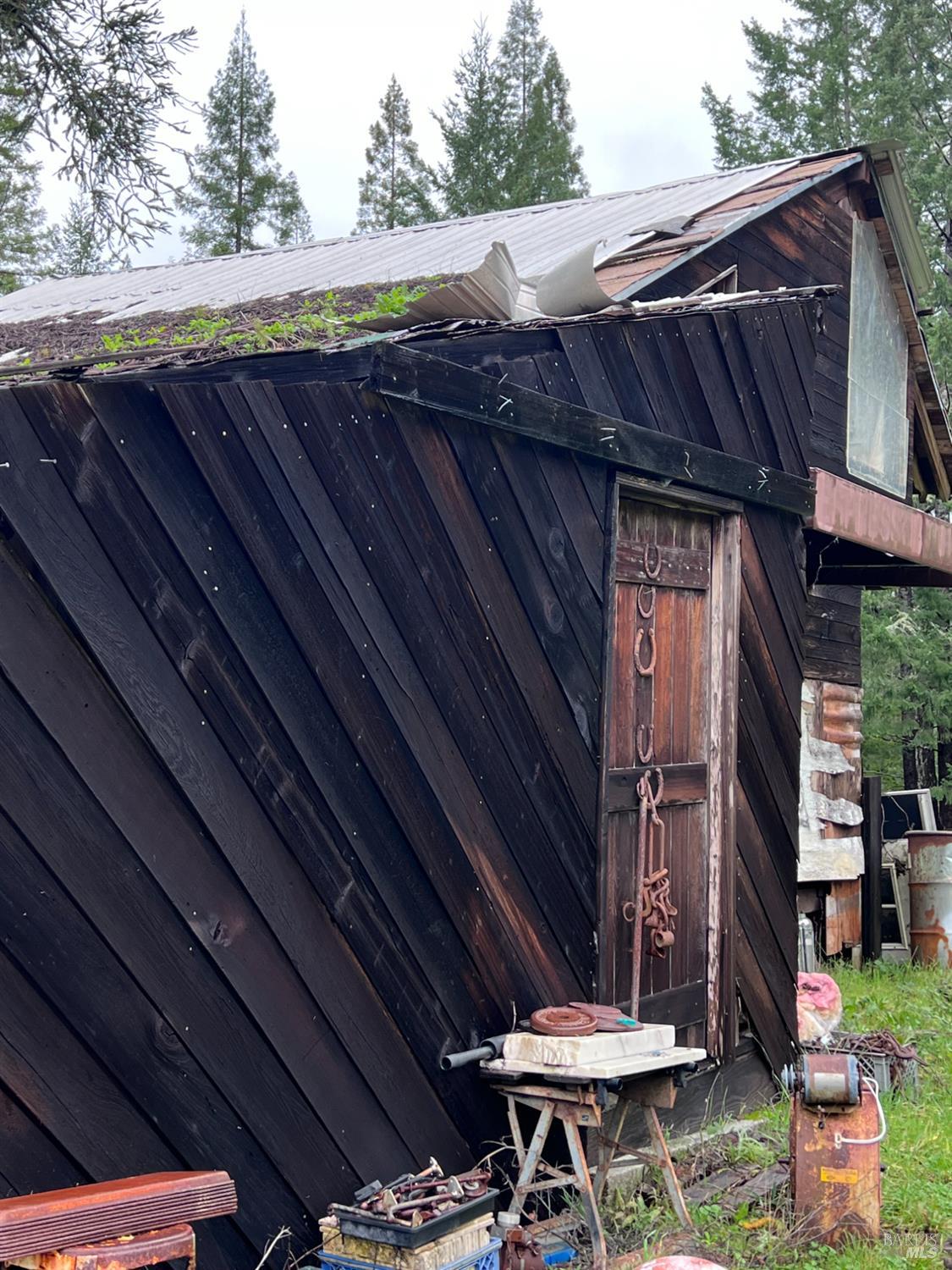 15785 Pole Mountain Road Cazadero, CA 95421 - Photo 13 of 44 a view of a backyard with table and chairs with wooden floor and fence