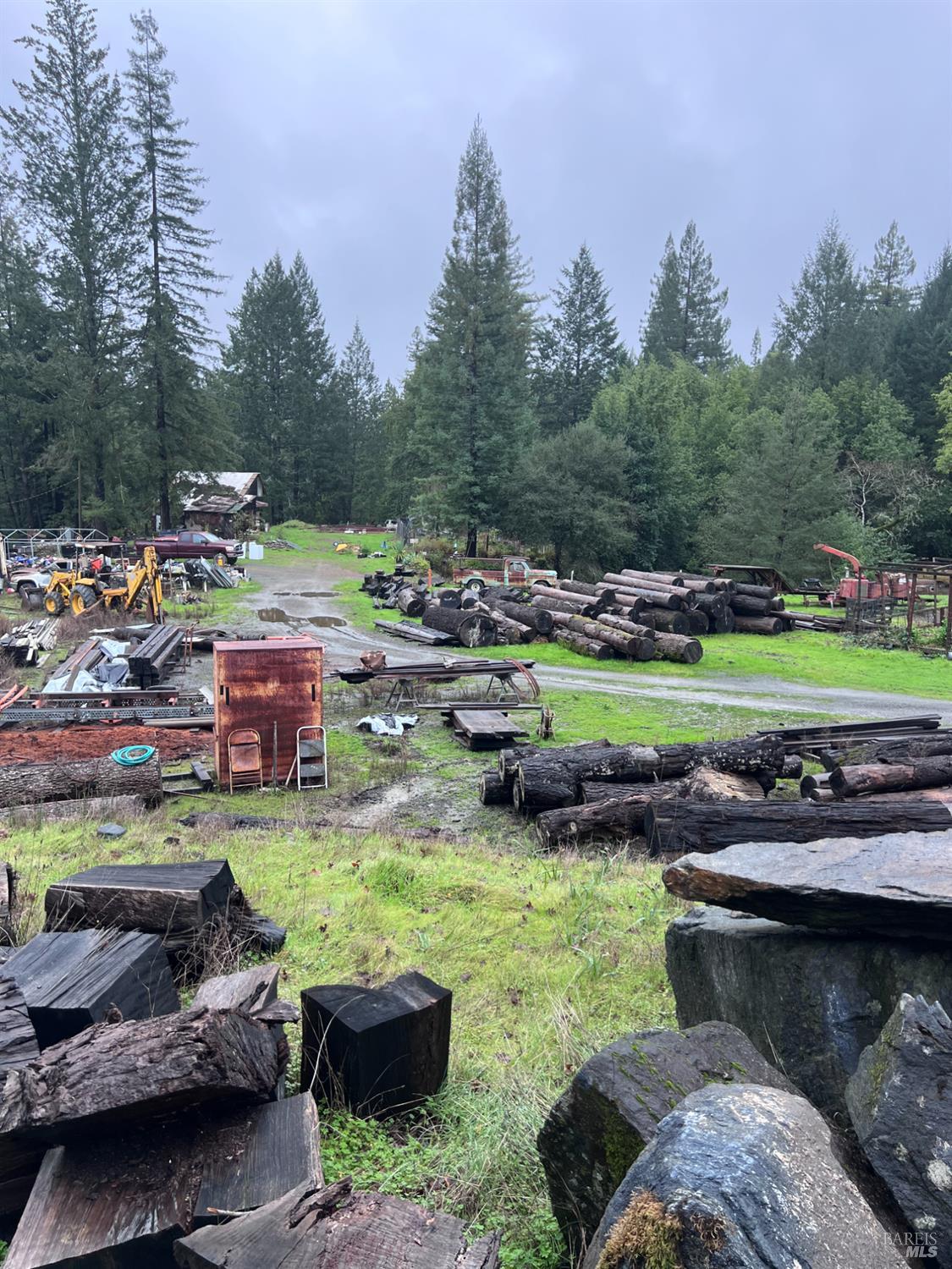 15785 Pole Mountain Road Cazadero, CA 95421 - Photo 9 of 44 a view of a backyard with lawn chairs and a fire pit