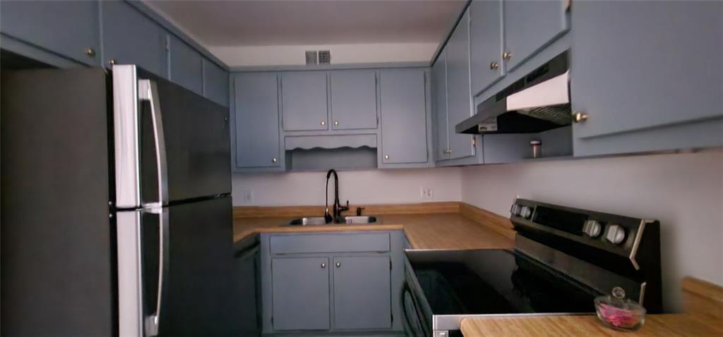 16 South East Street Jasper, GA 30143 - Photo 3 of 6 a kitchen with a sink stainless steel appliances and cabinets