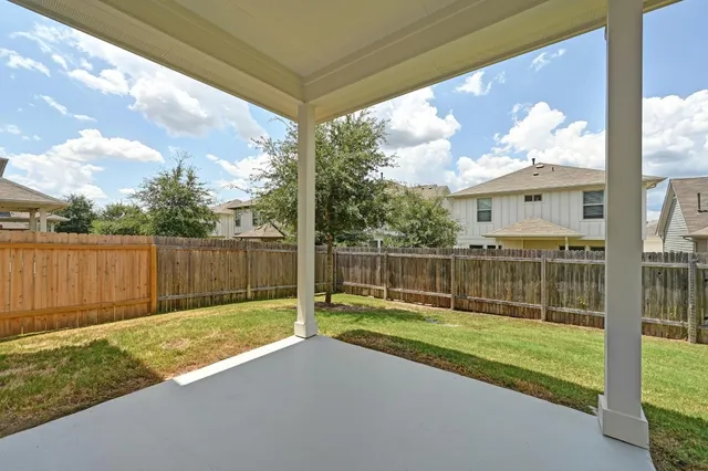 a view of a house with a yard and sitting area