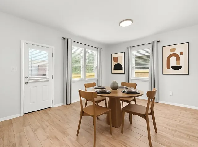 a view of a dining room with furniture and wooden floor