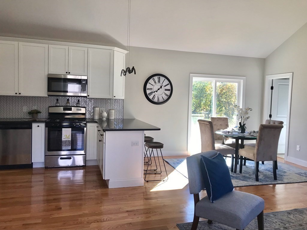 3 Beeden Road, Unit B Westport, MA 02790 - Photo 4 of 42 a view of kitchen with dining table chairs and wooden floor