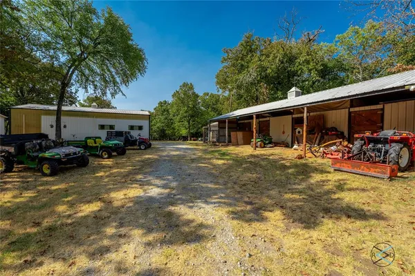 a view of a patio with table and chairs under an umbrella
