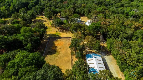 a view of a house with a yard and trees