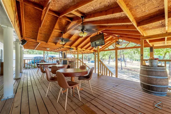 a view of a patio with table and chairs and wooden floor