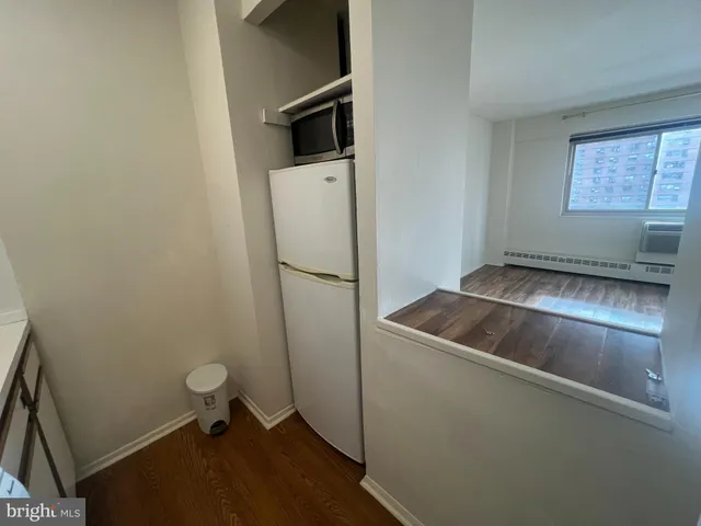 a kitchen with a refrigerator and a sink